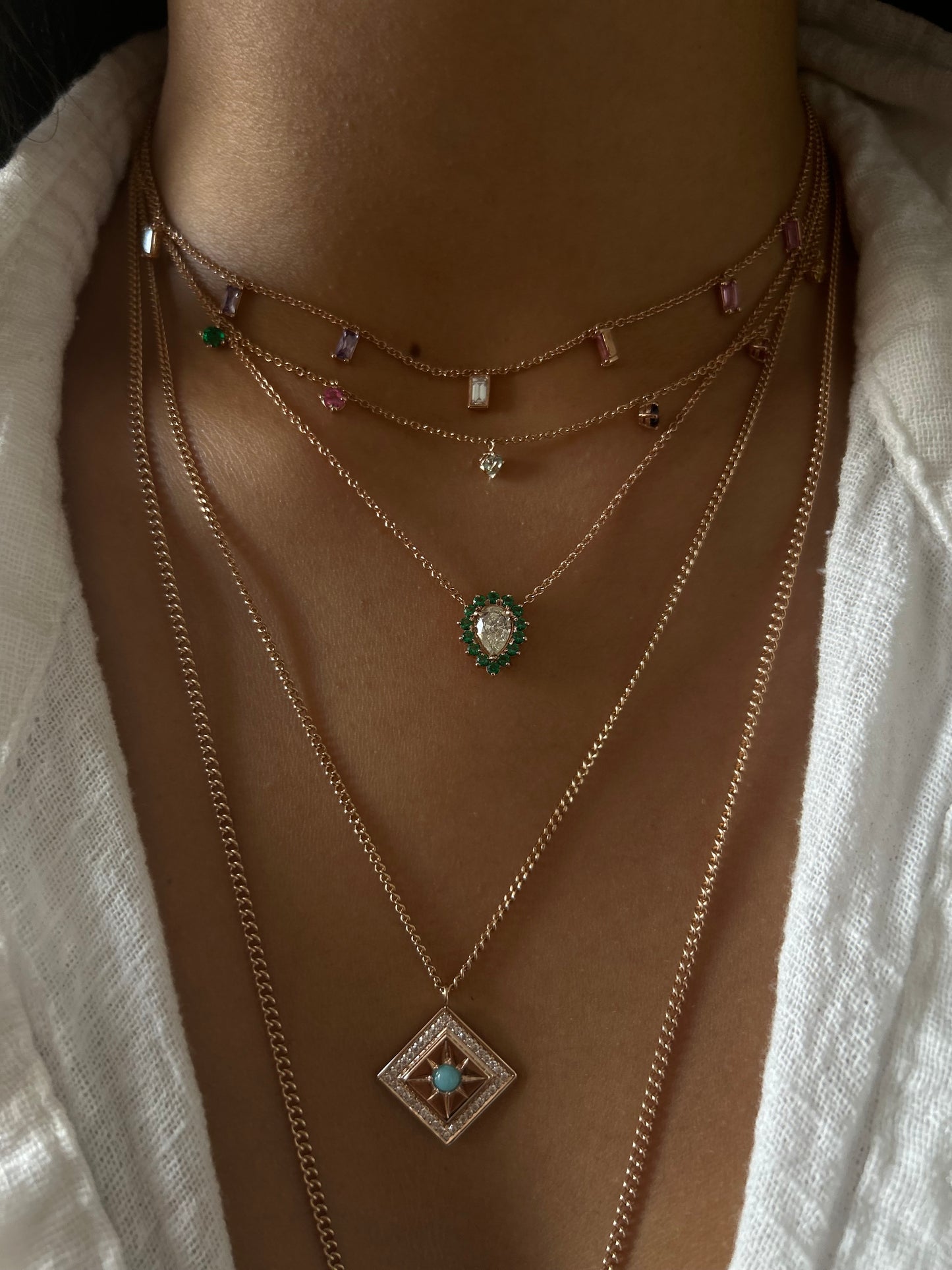 Drop diamond with round emeralds